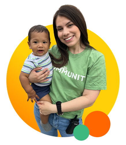 Sunbeam Employee smiling and holding child